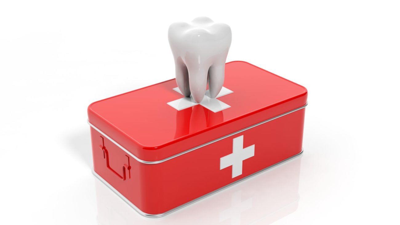 3D tooth sitting on first aid kit for dental emergency dentist in East Elmhurst New York